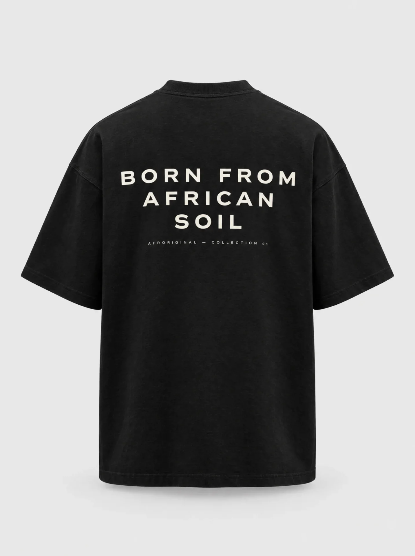 Black oversized T-shirt, back view, with BORN FROM AFRICAN SOIL printed in off-white capital letters across the upper back