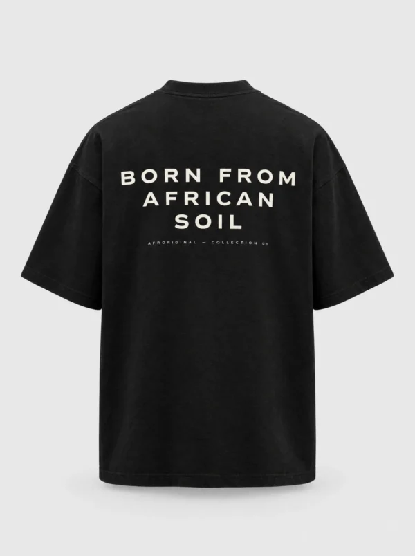 Black oversized T-shirt, back view, with BORN FROM AFRICAN SOIL printed in off-white capital letters across the upper back